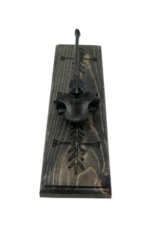 Image of blackened elk vertebra and home protection bindrunes wall hanger