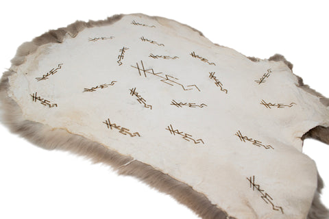 Image of burnt rabbit hide altar cloth - repeating bindrunes to invoke Freya
