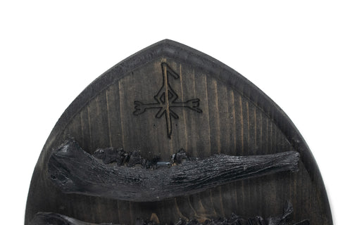 Image of norse god Loki and blackened jawbones altar