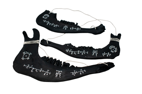 Image of blackened jawbone hanger to prevent harm from pets and livestock