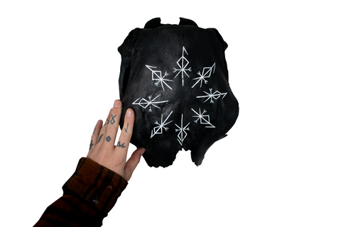 Image of partial cow skull with repeating Loki bindrunes