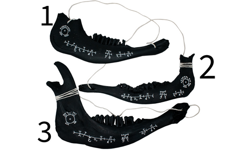 Image of blackened jawbone hanger to prevent harm from pets and livestock